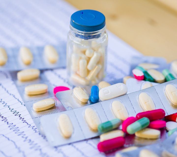 Assorted Pills With A Bottle And Prescription Sheets
